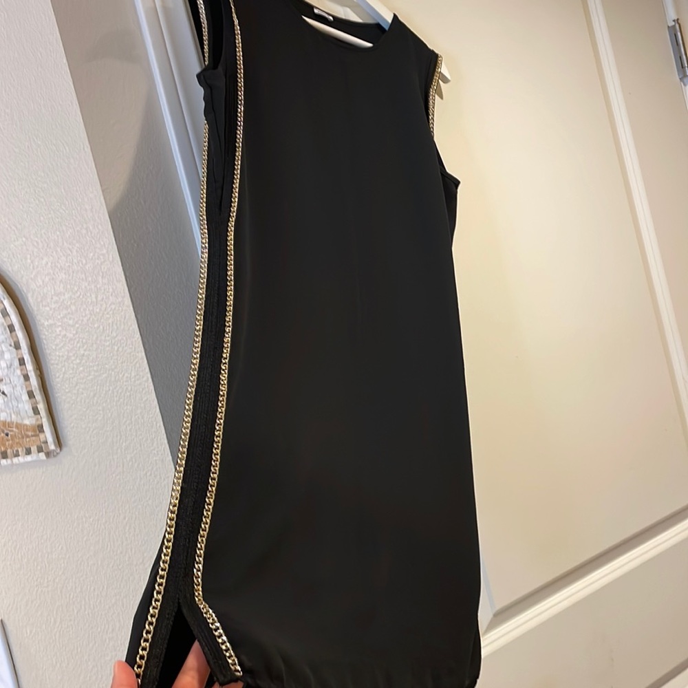 a black dress with golden chains on both sides, 2 small slits from both sides.